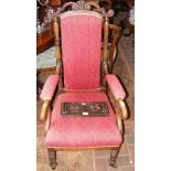 A 19th century library chair with scroll arms and