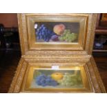 A pair of antique still life oils of fruit in gilt