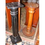 An antique ebonized pedestal, together with one ot
