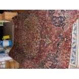 A large antique carpet with geometric border and c