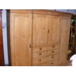 A large antique pine break-front triple wardrobe,