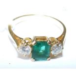 An emerald and two stone diamond ring in 18ct gold