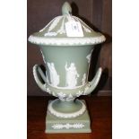 A Wedgwood green jasper ware urn and cover