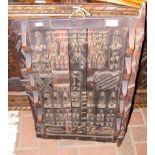 A Dogon carved wooden panel depicting figures and