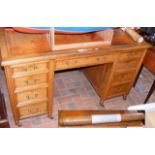 An Edwardian pedestal desk with nine drawers to th