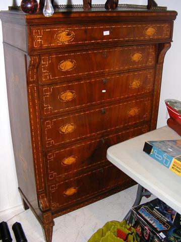 A continental inlaid chest of drawers with galleri