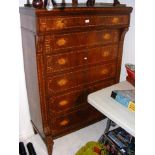 A continental inlaid chest of drawers with galleri