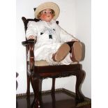 An antique bisque head doll with composite body -