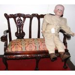 A bisque head doll, together with a doll's settee