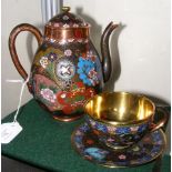 A decorative cloisonne teapot and matching cup and