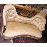 A Victorian settee with shaped button back