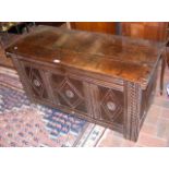 A period oak panelled coffer with carved front