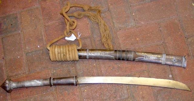 An antique Middle Eastern curved sword in white me