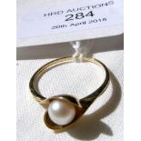 A pearl ring in gold setting - Size N