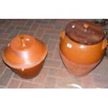 An earthenware plant pot and cover and a ditto wit