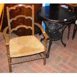 Cast iron pub table, together with a ladder back c