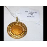 A Saudi Arabian gold coin in 18ct gold mount