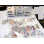 Nine plastic containers with collectable stamps fr