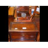 An antique rosewood tea caddy with fitted interior