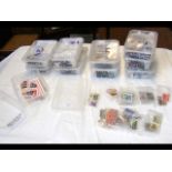 Ten plastic containers with loose stamps relating