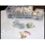 Twelve plastic containers with collectable stamps