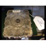 A decorative silver card case with engraved decora