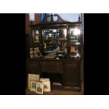 An antique mirrored back sideboard with drawers an