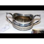 A silver two handled sugar bowl with London hallma