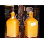 A pair of 20cm high orange glass brandy and whisky