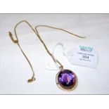 A large amethyst pendant in 9ct gold mount with ch