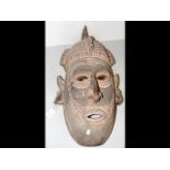 A large carved wooden mask from the Tami Island -