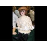 An antique bisque head doll with composite body by