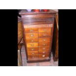 An antique tambour fronted multi-drawer unit