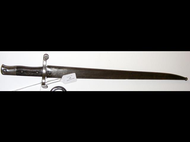 An antique sword bayonet with metal scabbard