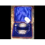 Pair of silver table salts and spoons in presentat