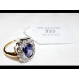 A tanzanite and cubic zirconia cluster ring with C