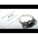 A diamond and sapphire three stone ring in 18ct go