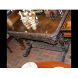 Carved Victorian oak side table with Dolphin suppo