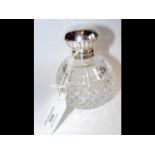 Silver lidded cut glass globular scent bottle