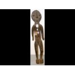 A carved wooden female figure from the Sepik regio