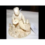 Carved ivory group of man holding fan - having sig