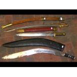 A large kukri and sheath, together with two other