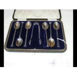 A cased set of six silver teaspoons with sugar ton