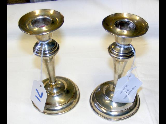 A pair of silver candlesticks - 13.5cm high
