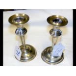 A pair of silver candlesticks - 13.5cm high