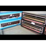 Four boxed model railway carriages, including Inte