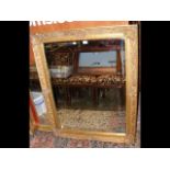 A large decorative gilt bevelled wall mirror