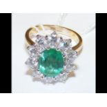 A lady's attractive emerald and diamond cluster ri