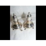 A pair of silver salt and pepper pots - 9.5cm high