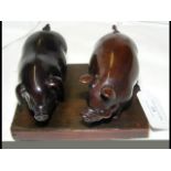 Two carved hardwood Japanese model pigs, with Mothe